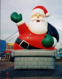 giant santa coming out of chimney advertising inflatable